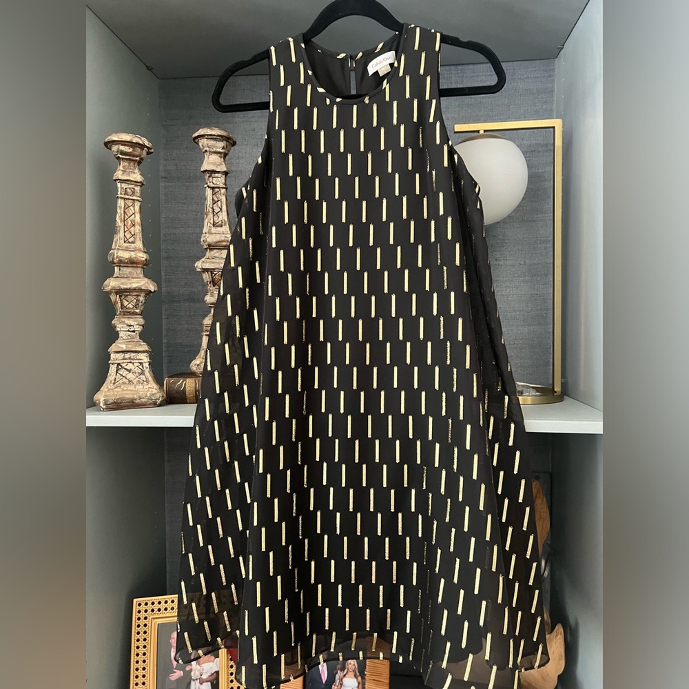 Black cocktail dress with metallic gold details
